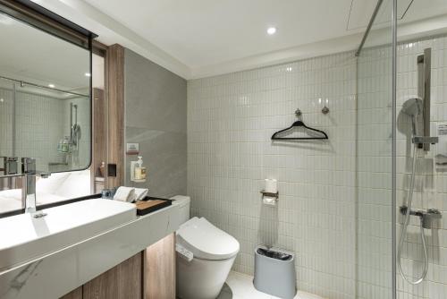 a bathroom with a toilet and a sink and a shower at Spring Rhapsody Hotel in Taichung