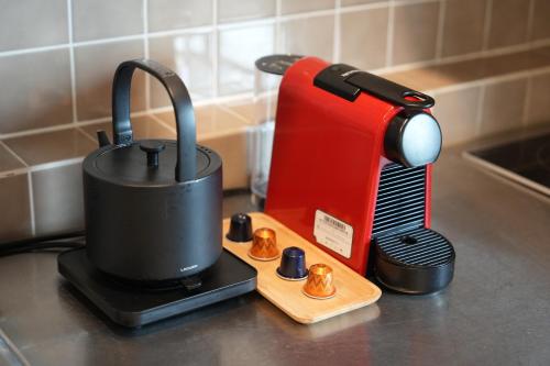 a kitchen counter with a tea kettle on a stove at Jeju Geumeum in Seogwipo