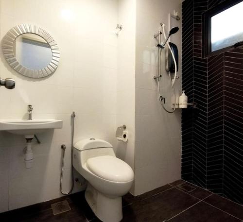 a bathroom with a toilet and a sink and a mirror at The Horizon Ipoh 2BR L11 by Grab A Stay in Ipoh