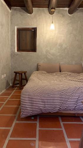 a bedroom with a bed and a table in it at Daughter and son in Jinhu