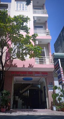 a pink building with a sign in front of it at Nhà Nghỉ KHÁNH NGỌC in Vung Tau
