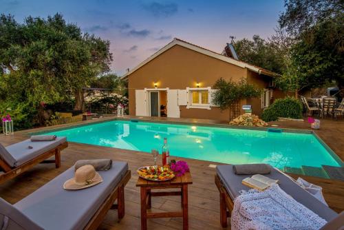a swimming pool in a backyard with a house at Vasia's Artistsvillas in Gaios