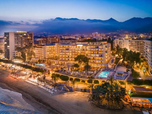 a city at night with a beach and buildings at El Fuerte Marbella in Marbella