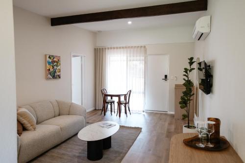 a living room with a couch and a table at The Timothée Resort in Busselton