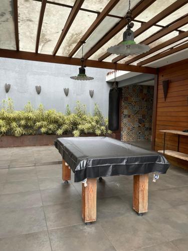 a ping pong table in the middle of a patio at Casa em Freguesia (Jacarepaguá) in Rio de Janeiro