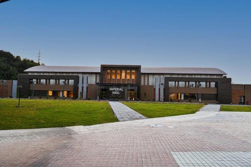 a large brick building with a brick walkway in front of it at Jacaranda Heights in Islamabad
