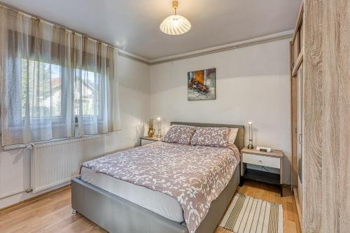 a bedroom with a bed and a large window at House Pepica With Hot Tub - Happy Rentals in Kraljevec na Sutli