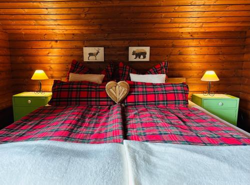 a bedroom with a bed with a heart on it at Holidayhome Knusperhäuschen in Sattendorf