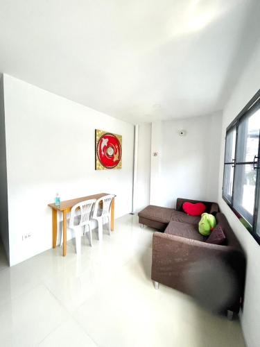 a living room with a couch and a table at Inn Trog And Inn Soi in Bangkok