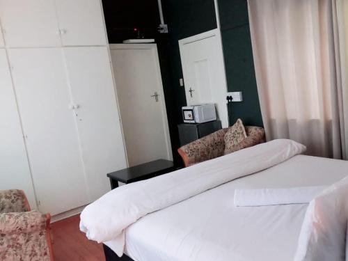 Postel nebo postele na pokoji v ubytování Mino Guest House