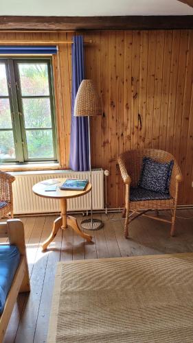 a living room with a table and a chair at Alte Ausspanne in Walkendorf