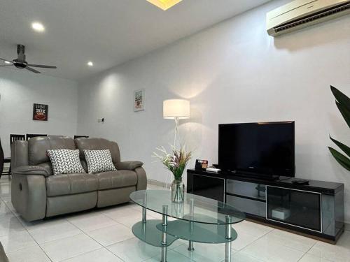 a living room with a couch and a tv and a glass table at Cendana House@Juru/Autocity/Bkt Minyak/Batu Kwan/IKEA in Simpang Ampat