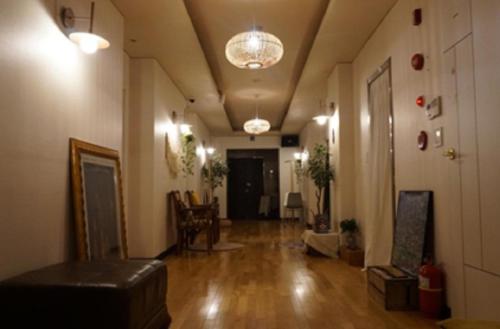 a living room with a hallway with a hard wood floor at Hanra guesthouse in Jeju