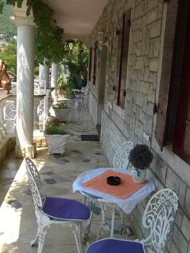 a table and chairs sitting on a patio at Apartments and Rooms Deskovic in Mošćenička Draga