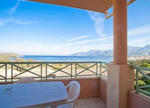 a balcony with a table and a view of the ocean at Appartement dans la residence calme in Saint-Florent
