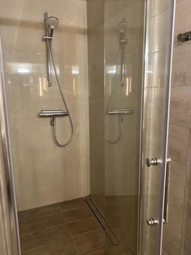 a shower with a glass door in a bathroom at Anatole - T3 - Moderne - Climatisé - 1er étage - Très grande terrasse - Vue magnifique et dégagée in Saint-Mandrier-sur-Mer