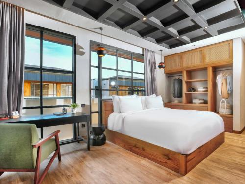 坎古的住宿－Secana Beachtown，一间卧室配有一张床、一张书桌和窗户。