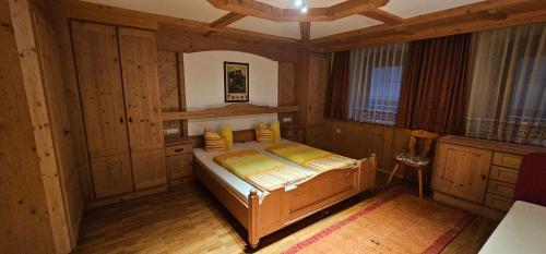 a bedroom with a bed in a wooden room at Hotel-Garni Pramstraller in Mayrhofen