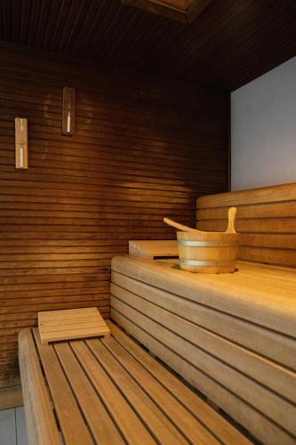 a sauna with a wooden tub and wooden steps at Hotel Rudy in Riva del Garda