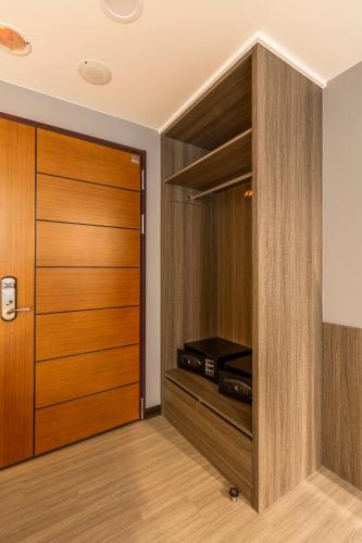 a room with a closet with wooden doors at San Chiao Hotel in Daxi