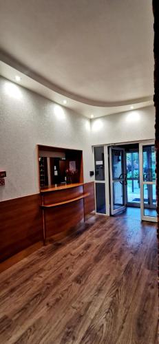 an empty room with a wooden floor and glass doors at Płonia Resort in Szczecin