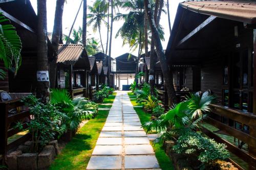 a walkway through the courtyard of a resort at O3 Beach Resort in Palolem