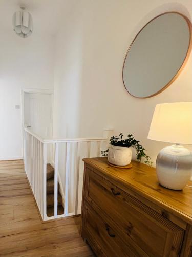 a mirror sitting on top of a dresser in a room at 2025 Award Winner Liverpool Peach House - 4 Bedrooms in Liverpool