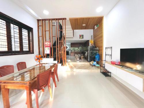 a living room with a wooden table and chairs at Kemnpi Homestay in Hue
