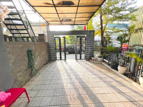 an open door of a building with a red bench at Kemnpi Homestay in Hue