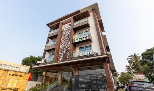 a building with a sign on the front of it at Treebo Four Seasons in Mysore