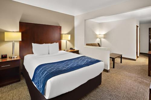a hotel room with a large bed and a desk at Comfort Inn Lacey - Olympia in Lacey