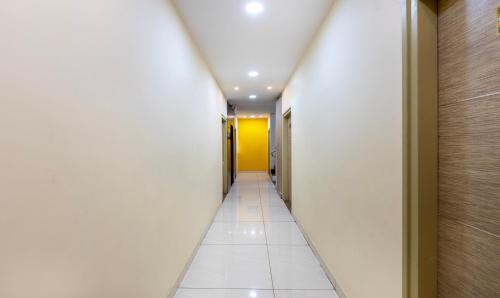 a corridor in a building with a hallway at Treebo Four Seasons in Mysore