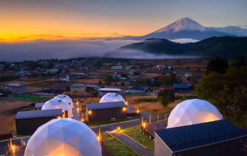 a group of domes with a mountain in the background at グランファーム富士河口湖 in Fujikawaguchiko