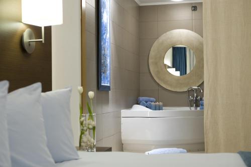 a bathroom with a sink and a mirror at Domotel Xenia Volos in Volos