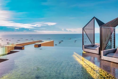 a view of the water from a hotel pool at EDGE Sea View Holiday inn Pattaya Central in Pattaya