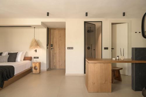 a bedroom with a bed and a wooden desk at The Syntopia Hotel - Adults Only in Adelianos Kampos