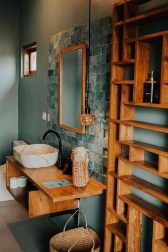 a bathroom with a sink and a mirror at Disini Lombok ECO Sky House with Sea view in Selong Belanak