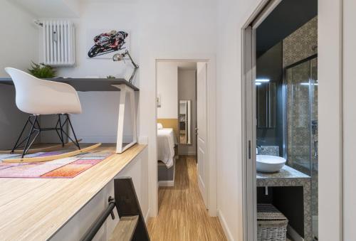 a bathroom with a sink and a white chair at Easylife - Tranquillo studio vicino Prada in Milan