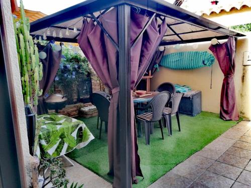 a gazebo with a table and chairs in a garden at Mikalita in San Fernando