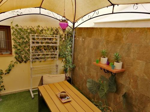 a patio with an umbrella and a table with plants at Mikalita in San Fernando