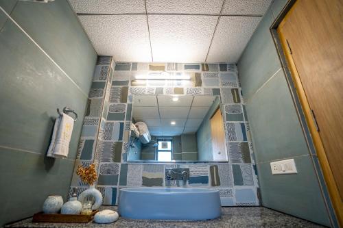 a bathroom with a sink and a mirror at Vacanza By Westay Luxury Home in Gurgaon