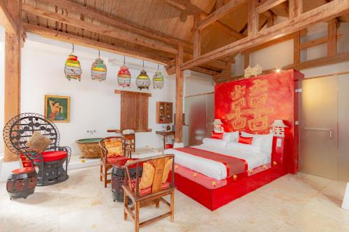 a bedroom with a bed and a table and chairs at Bali Ginger Suites & Villa in Seminyak