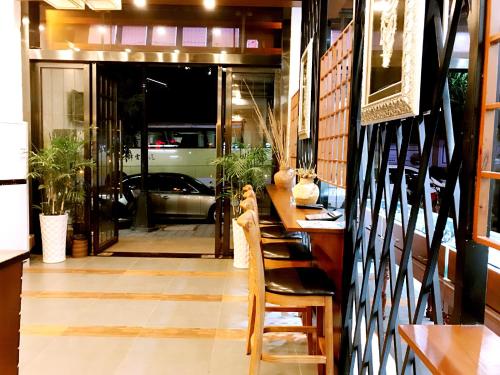 a restaurant with a table and chairs and a view of a door at Family Hotel Zhangjiajie in Zhangjiajie