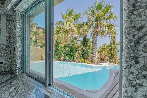 a view of a swimming pool through a window at Calilo in Manganari
