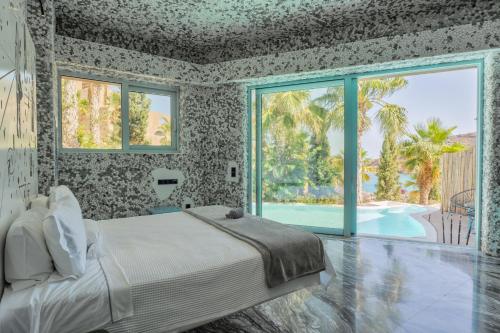a bedroom with a bed and a swimming pool at Calilo in Manganari