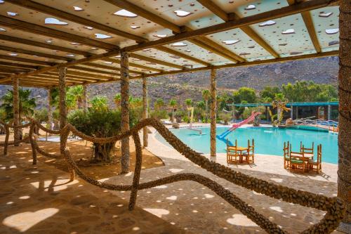 a large swimming pool with a slide in a resort at Calilo in Manganari
