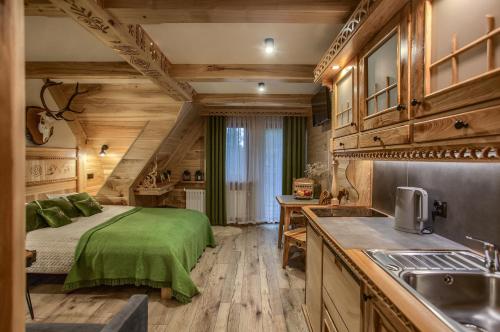 Apartamenty u Grażyny في مورزاسيخله: غرفة نوم في كابينة خشب بها سرير ومغسلة