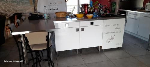a kitchen with white cabinets and a counter top at Villa Sand 5mn château goutelas in Marcoux