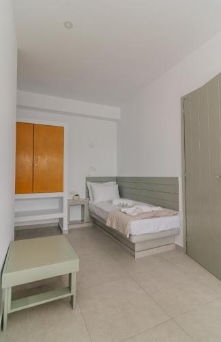 a bedroom with a bed and a table at Olive Garden Luxury Resort in Angairiá