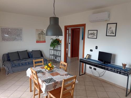 a living room with a table and a couch at Degli Angioini Holiday Home in Caulonia Marina